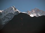 Annapurna 11 01 Manaslu Southwest Face From Dhanagyu I left at 6:20 and after crossing to the Annapurna circuit, I back tracked to upper Dharapani (1920m) to get my Annapurna trekking permit stamped. Thirty minutes later, I walked through Bagarchap (2160m), which was also hit by the same storm that produced avalanches in eastern Nepal in November 1995. A landslide roared through Bagarchap and destroyed much of the village, including two lodges. The trek has now entered the east-west Manang valley and travels west up the valley with high Himalayan peaks to the south. From Dhanagyu I looked toward Manaslu and the Southwest face popped up above the intervening ridge.